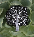 Tree Enamel Pin by Jenny Wood Art. Pictured displayed atop a succulent