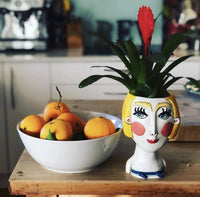 Darcell Abstract Lady Planter by Allen Designs. Pictured displayed in a rustic kitchen with a Bromeliad plant