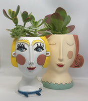 Darcell Abstract Lady Planter by Allen Designs. Pictured with succulent plants, alongside the Red Rose Lady Planter by Allen Designs