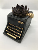Baby black typewriter planter by Allen Designs. Pictured planted with a black prince succulent