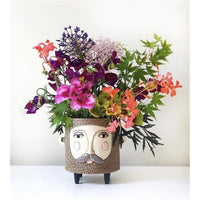 Baby Hairy Jack Planter by Allen Designs. Pictured with a bouquet of flowers