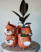A collection of Allen Designs Baby Fox Planters
