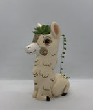 Baby Llama Vase / Planter by Allen Designs. Pictured planted with an echeveria succulent and string of pearls