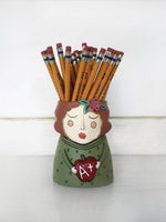 Baby Teacher Planter by Allen Designs. Pictured as a pencil holder