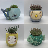A collection of 4 different planters by Allen Designs, including the Baby Fish Planter