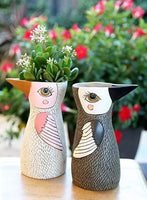 White bird vase or watering can by Allen Designs. Pictured with brown bird vase or watering can by Allen Designs holding Jade succulent