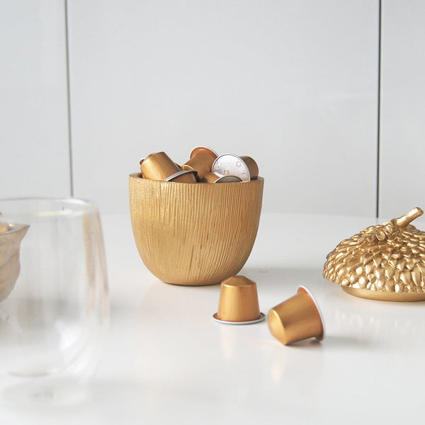 Gold Secret Acorn Box by White Moose. Pictured displayed in a kitchen with coffee capsules