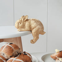 Gold Shelf Bunny by White Moose. Pictured hanging off a coffee table